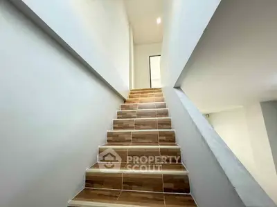 Modern staircase with wooden steps in a minimalist home interior