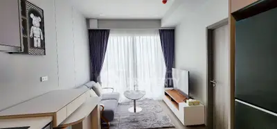 Modern living room with stylish decor and large window for natural light.