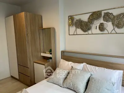 Modern bedroom with stylish wooden furniture and elegant wall art, perfect for a cozy living space.