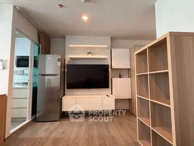 Modern living room with sleek TV unit and spacious shelving in stylish apartment.