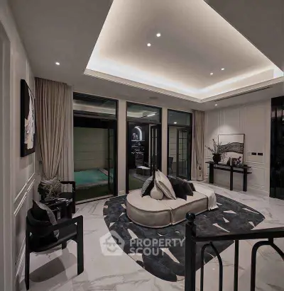 Luxurious living room with modern decor and elegant lighting, featuring a stylish round sofa and large windows.