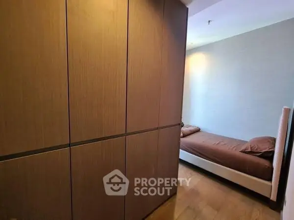 Cozy bedroom with wooden wardrobe and modern design