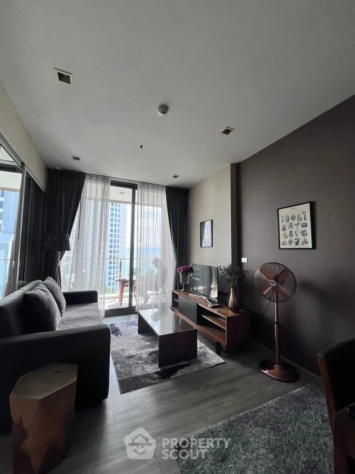 Modern living room with stylish decor and city view balcony