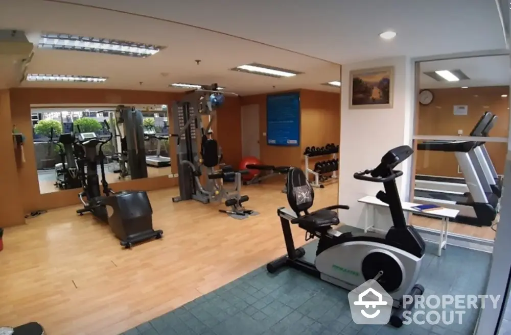 Spacious gym with modern fitness equipment in a residential building