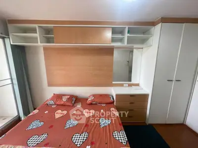 Cozy bedroom with built-in storage and heart-themed bedding, perfect for a warm and inviting atmosphere.