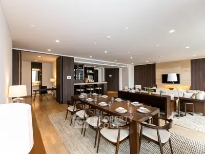 Luxurious open-plan living and dining area with modern decor and ample natural light.