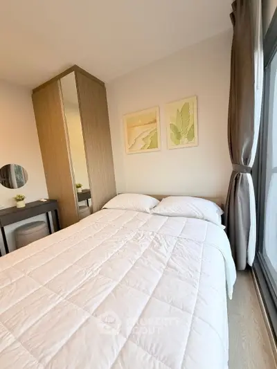 Cozy bedroom with large window and stylish decor in modern apartment