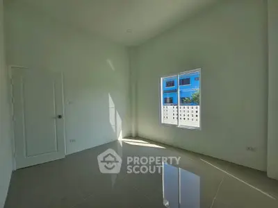 Bright empty room with glossy tiled floor and large window, perfect for customization.