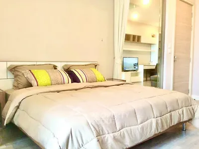 Spacious bedroom with modern decor and cozy bedding in a stylish apartment.