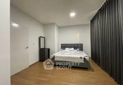 Modern bedroom with sleek design and cozy ambiance, featuring a comfortable bed and stylish decor.