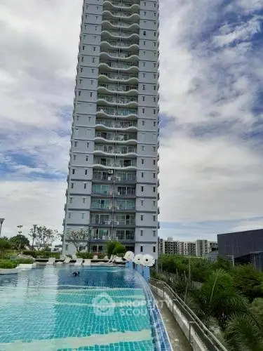 Stunning high-rise building with infinity pool and lush greenery, perfect for luxury living.