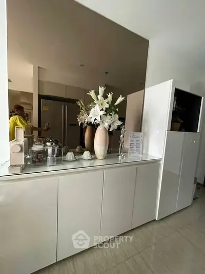 Modern kitchen with sleek cabinetry and elegant decor in a stylish apartment.