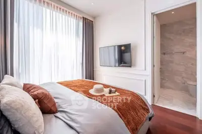 Luxurious bedroom with ensuite bathroom, elegant decor and natural light.