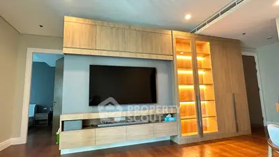 Modern living room with sleek wooden entertainment center and ambient lighting