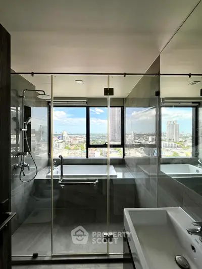 Luxurious bathroom with stunning city view from large windows, featuring modern fixtures and glass shower enclosure.