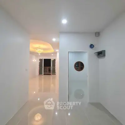 Spacious modern interior with elegant lighting and glossy floors, perfect for luxurious living.