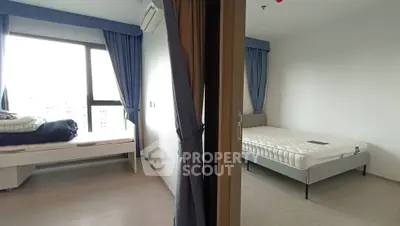 Spacious dual-bedroom apartment with modern furnishings and large windows for natural light.