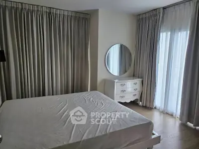Spacious bedroom with elegant curtains and a stylish dresser, perfect for a serene retreat.