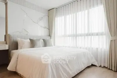 Elegant bedroom with large window and luxurious marble accent wall