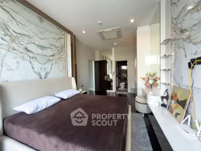 Luxurious bedroom with marble accents and modern decor in upscale apartment