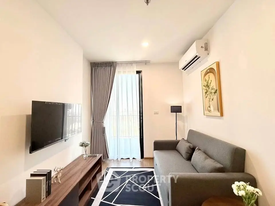 Modern living room with sleek furniture and natural light, featuring a stylish sofa and wall-mounted TV.