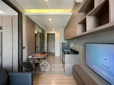 Modern open-layout kitchen with sleek cabinetry and integrated appliances in a stylish apartment.