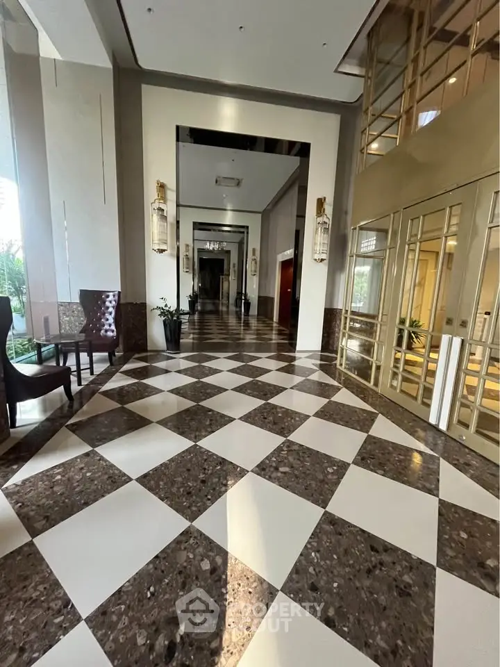 Luxurious building entrance with elegant checkered flooring and stylish decor