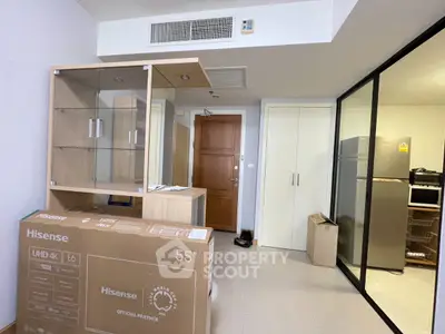 Modern apartment interior with kitchen and living area, featuring a Hisense 55-inch TV box and sleek design.