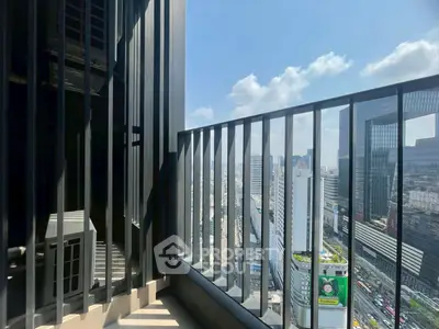 Stunning city view from a modern high-rise balcony with sleek railing design.