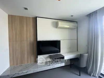 Modern living room with sleek TV unit and air conditioning