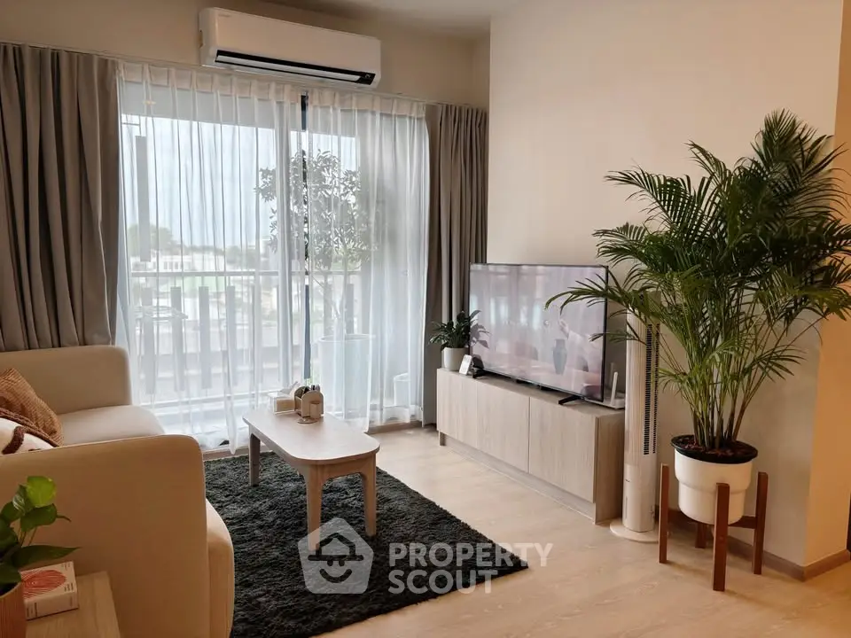 Modern living room with large window, stylish furniture, and lush plants.