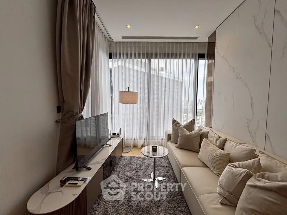 Luxurious modern living room with elegant decor and large windows offering natural light.