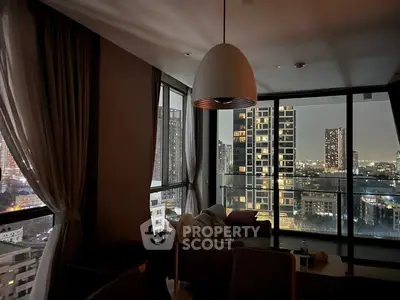 Stunning city view from modern living room with floor-to-ceiling windows and elegant decor.