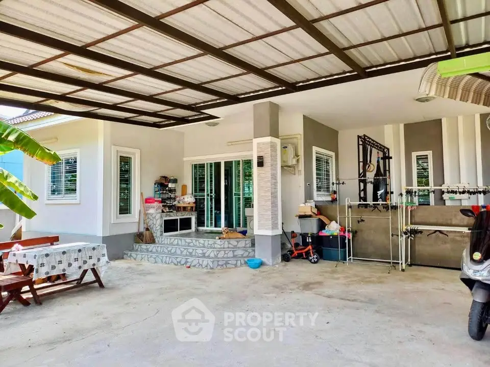 Charming home exterior with covered patio and modern design, perfect for outdoor relaxation and entertainment.