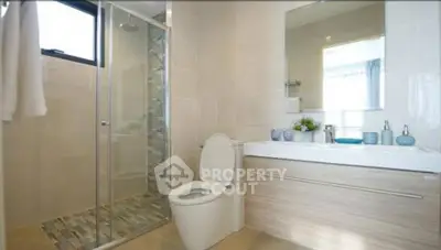 Modern bathroom with glass shower and sleek vanity