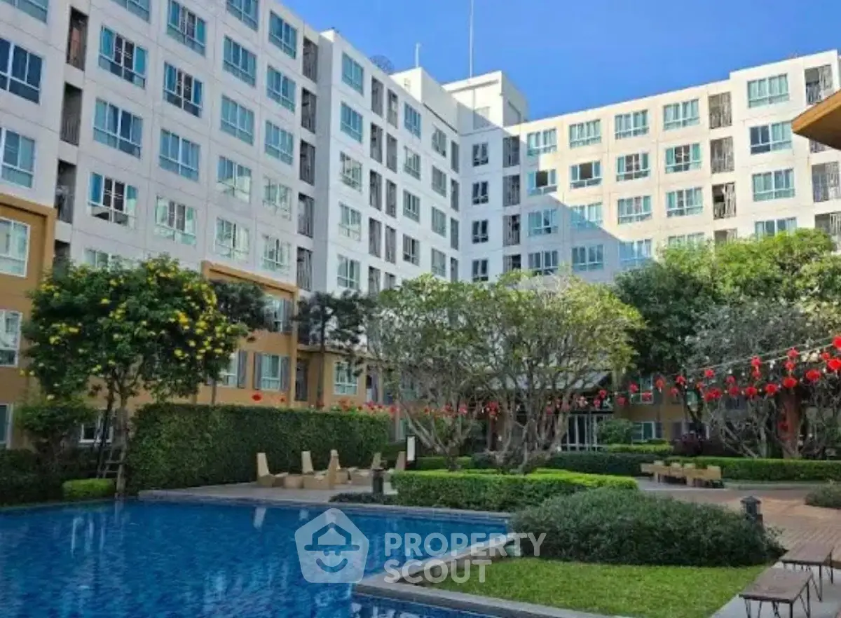 Modern apartment complex with pool and lush garden landscaping