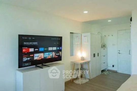 Modern living room with TV and cozy workspace in stylish apartment