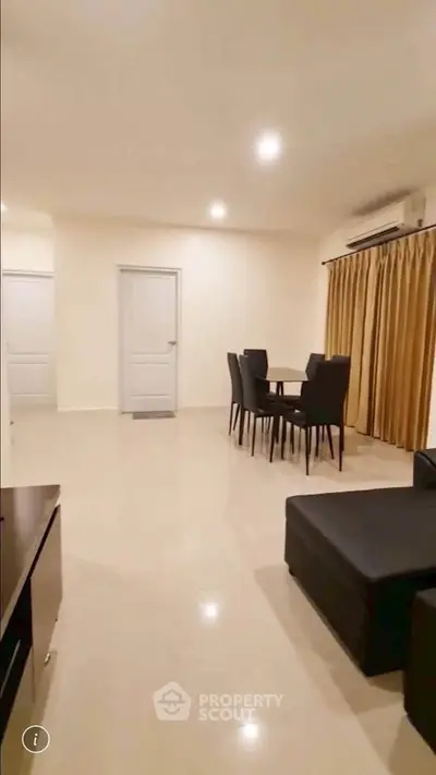 Spacious living room with modern furniture and elegant dining area