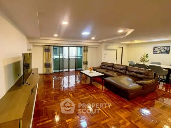 Spacious living room with polished wooden floors and modern furniture