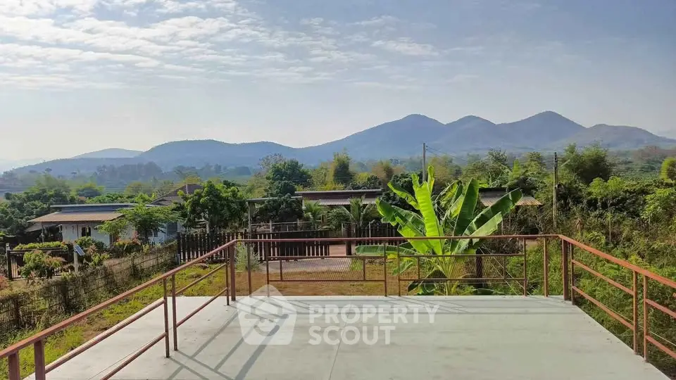 Stunning mountain view from a spacious balcony in a serene residential area.