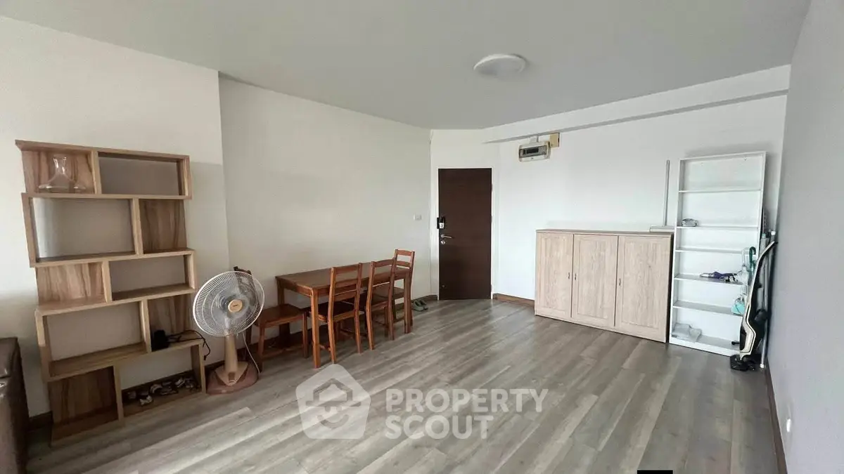 Spacious living room with modern wooden furniture and sleek flooring