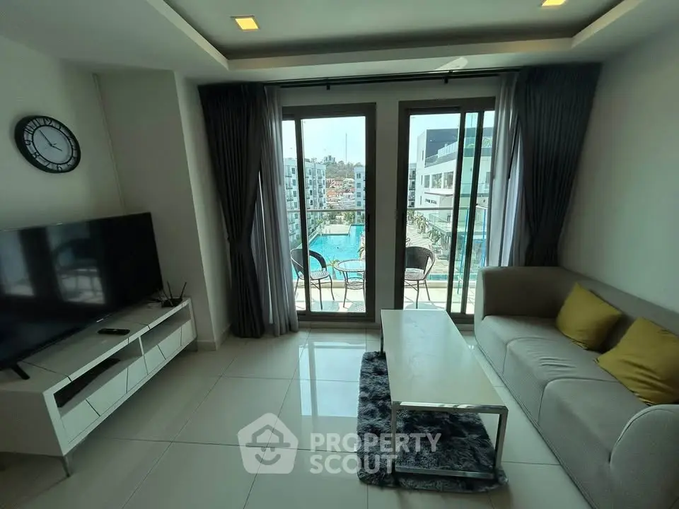 Modern living room with pool view, stylish furniture, and large windows in a luxury apartment.