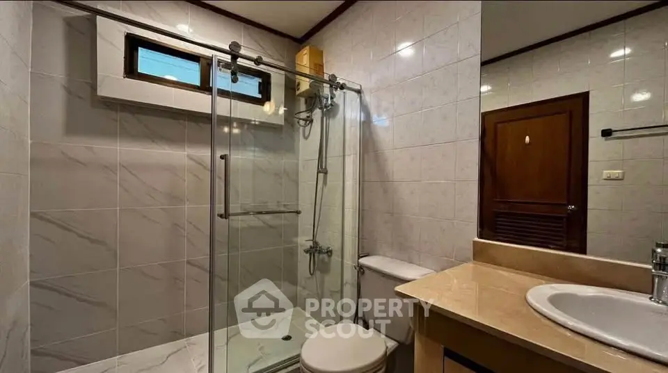 Modern bathroom with glass shower and elegant fixtures