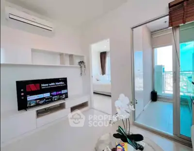 Modern living room with TV and balcony access in a stylish apartment