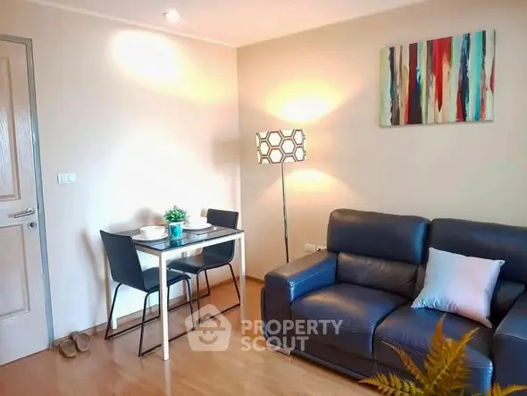 Cozy living room with modern decor and dining area, perfect for urban living.