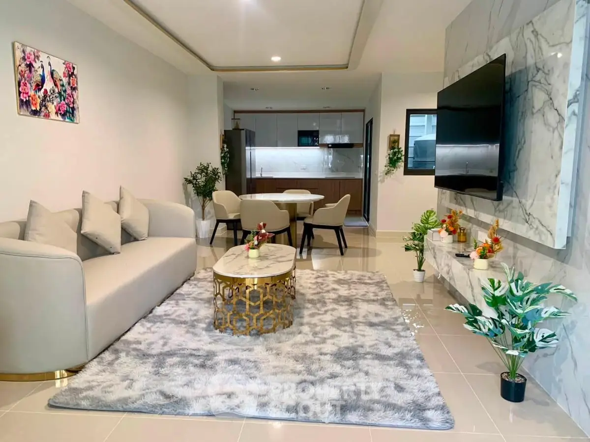 Luxurious modern living room with elegant decor and open kitchen layout, perfect for stylish urban living.
