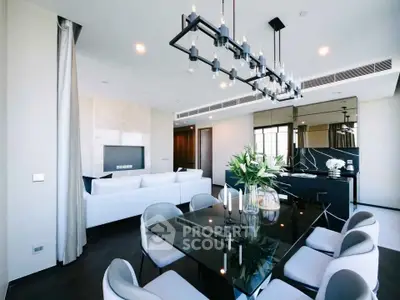 Luxurious modern living room with elegant dining area and stylish chandelier, perfect for sophisticated urban living.