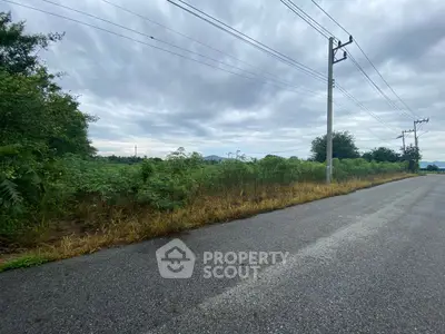 Expansive land plot with lush greenery and clear skies, ideal for development or investment opportunities.
