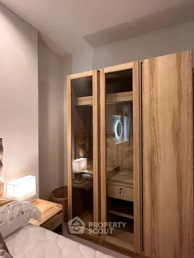 Cozy bedroom with elegant wooden wardrobe and soft lighting