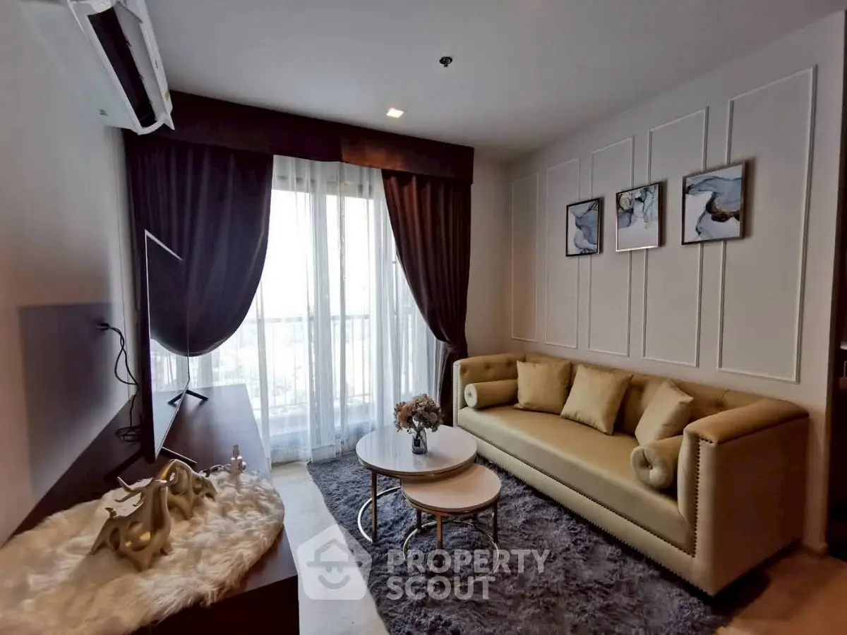 Stylish living room with elegant decor and large window offering natural light.